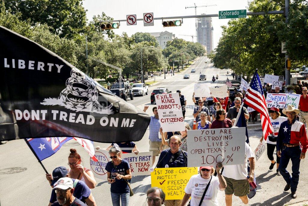 Bronte Wittpenn Hundreds gather in protest against Gov. Greg Abbott's handling of the coronavirus pandemic outside the governor's mansion in Austin on Saturday, Oct. 10, 2020. (Bronte Wittpenn /Austin American-Statesman via AP)