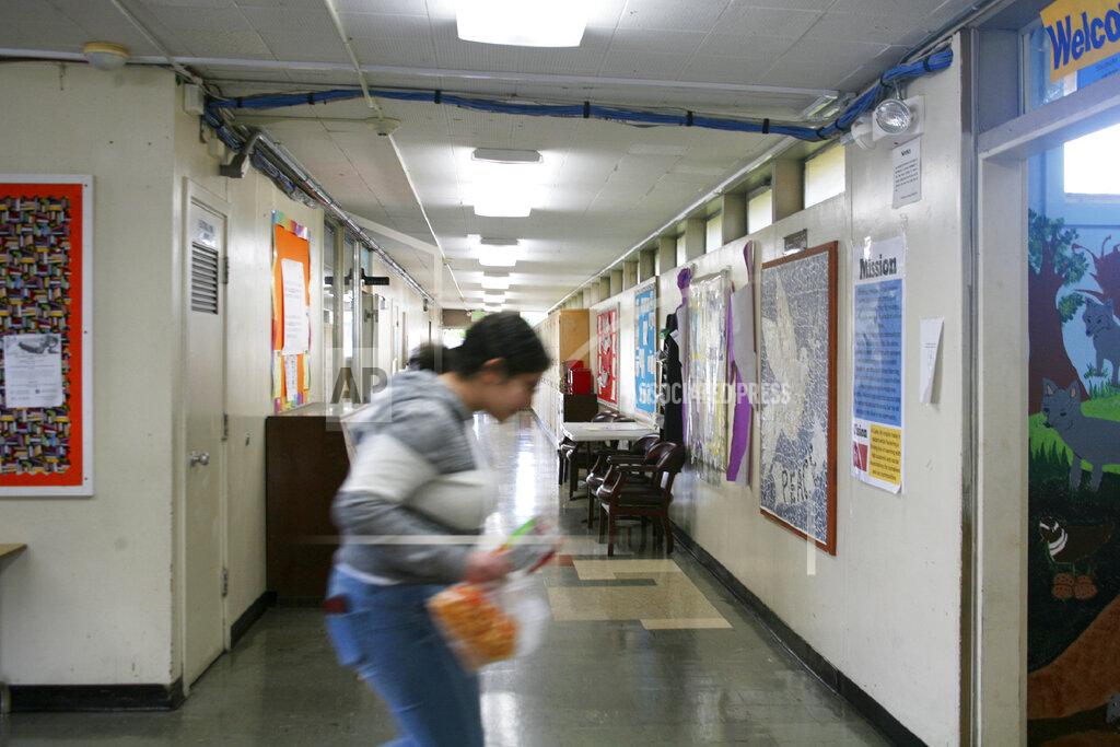 Jocelyn Gecker FILE - In this Jan. 27, 2020, file photo, a student walks through a hallway at Lake Elementary School in San Pablo, Calif. California's schools superintendent said Wednesday, May 20, 2020, he expects classes for the state's 6 million students to resume as usual in late August or September. (AP Photo/Jocelyn Gecker, File)
