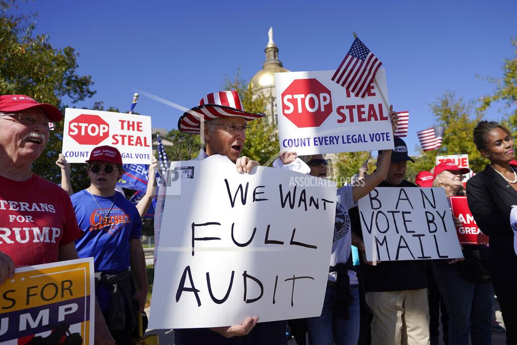 John Bazemore Supporters of President Donald Trump hold signs during a rally outside the Georgia State Capitol Friday, Nov. 13, 2020, in Atlanta. (AP Photo/John Bazemore)