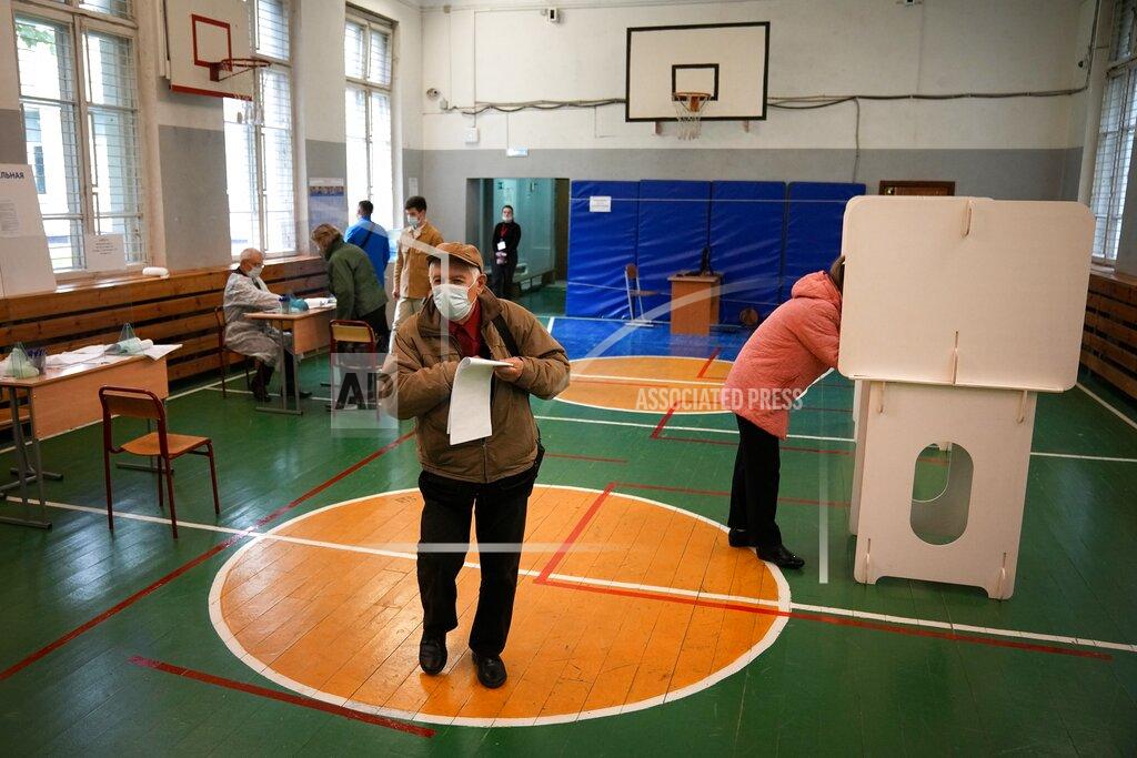 Alexander Zemlianichenko A man walks to casts his ballot at a polling station during the Parliamentary elections in Moscow, Russia, Friday, Sept. 17, 2021. Russia has begun three days of voting for a new parliament that is unlikely to change the country's political complexion. There's no expectation that United Russia, the party devoted to President Vladimir Putin, will lose its dominance in the State Duma. (AP Photo/Alexander Zemlianichenko)