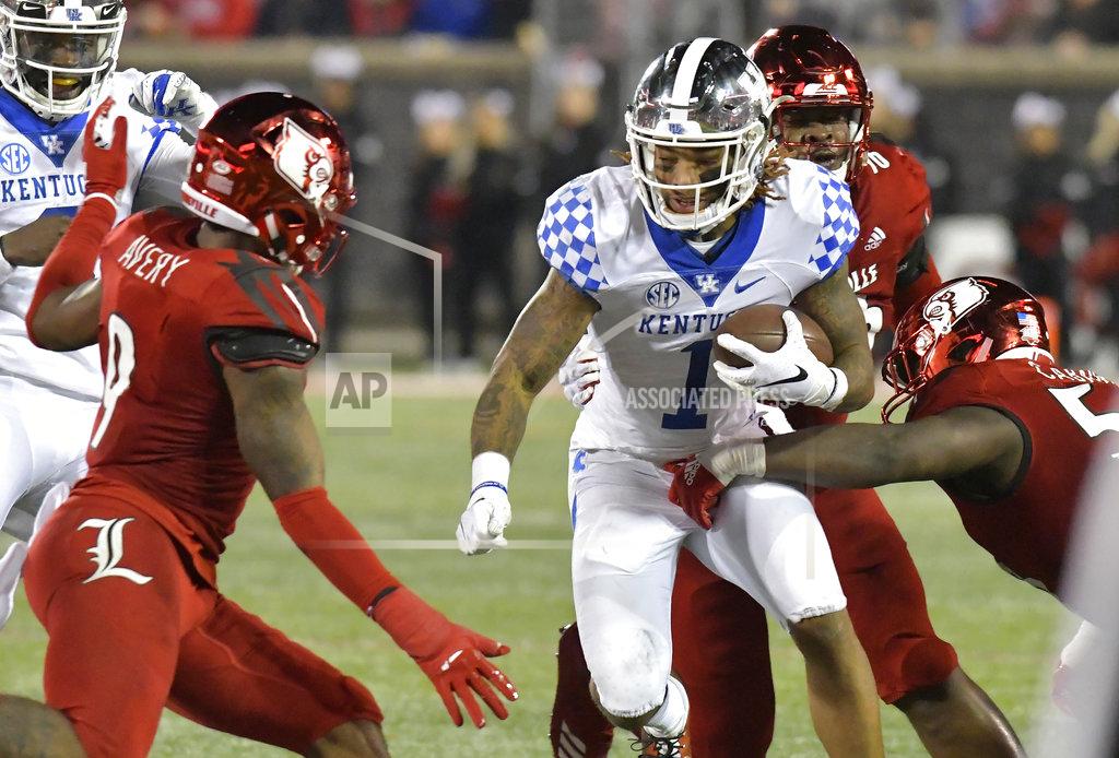 Timothy D. Easley Kentucky wide receiver Lynn Bowden Jr. (1) is wrapped up by Louisville defensive end Amonte Caban (53) during the second half of an NCAA college football game in Louisville, Ky., Saturday, Nov. 24, 2018. Louisville won 56-10. (AP Photo/Timothy D. Easley)