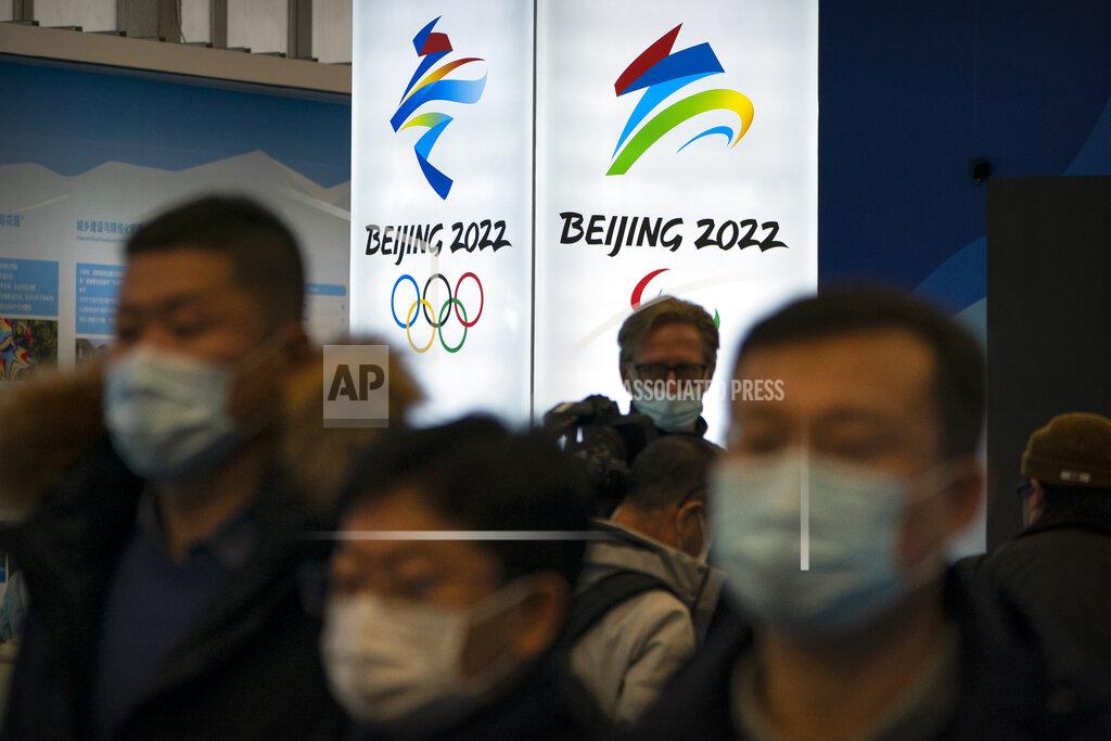 Mark Schiefelbein Attendees wearing face masks to protect against the spread of the coronavirus look at an exhibit at a visitors center at the Winter Olympic venues in Yanqing on the outskirts of Beijing, Friday, Feb. 5, 2021. Beijing Olympic organizers showed off the downhill skiing venue and the world's longest bobsled and luge track Friday, one year ahead of the scheduled opening of the 2022 Olympic Winter Games. (AP Photo/Mark Schiefelbein)