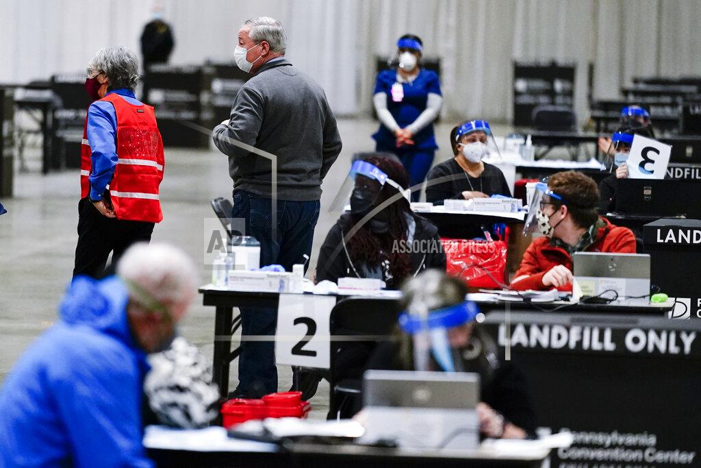 Matt Rourke Philadelphia Mayor Jim Kenney, center left, visits a COVID-19 vaccination site at the Pennsylvania Convention Center in Philadelphia, Wednesday, Feb. 3, 2021. (AP Photo/Matt Rourke)