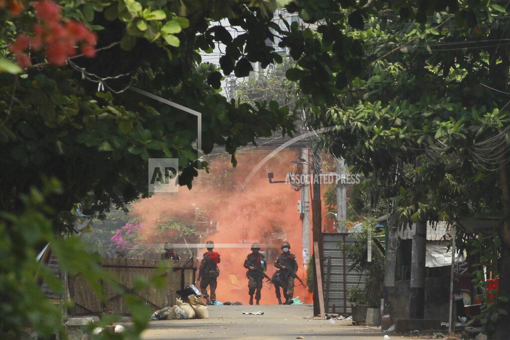 Soldiers walk towards anti-coup protesters during a demonstration in Yangon, Myanmar on Tuesday March 30, 2021. Thailand’s Prime Minister Prayuth Chan-ocha denied Tuesday that his country’s security forces have sent villagers back to Myanmar who fled from military airstrikes and said his government is ready to shelter anyone who is escaping fighting. (AP Photo)