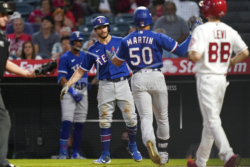 Ashley Landis Texas Rangers' Jason Martin (50) celebrates with Nick Solak, center left, after hitting a home run during the second inning of a baseball game against the Los Angeles Angels Friday, Sep. 3, 2021, in Anaheim, Calif. Solak also scored. (AP Photo/Ashley Landis)