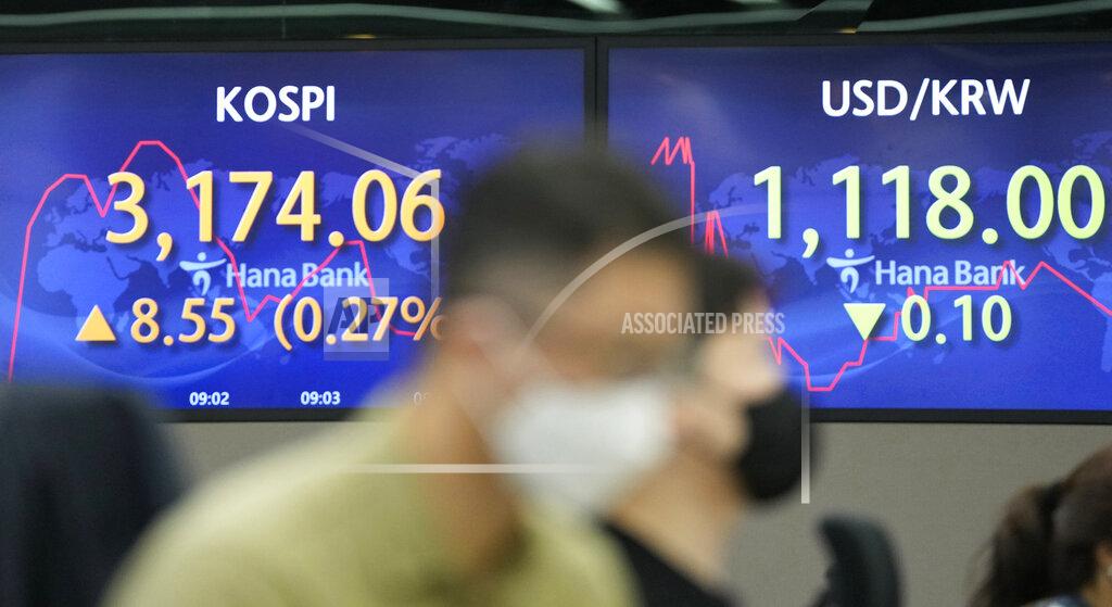 Lee Jin-Man Currency traders watch computer monitors near the screens showing the Korea Composite Stock Price Index (KOSPI), left, and the foreign exchange rate between U.S. dollar and South Korean won at the foreign exchange dealing room in Seoul, South Korea, Friday, May 28, 2021. Asian shares rose Friday, powered by encouraging signs that the U.S. economic recovery from the pandemic is gaining momentum. (AP Photo/Lee Jin-man)