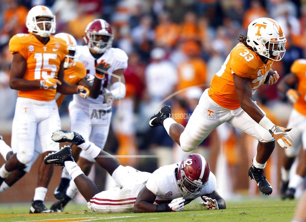 Wade Payne Tennessee running back Jeremy Banks (33) leaps as he escapes the grasp of Alabama linebacker Jaylen Moody (42) in the first half of an NCAA college football game Saturday, Oct. 20, 2018, in Knoxville, Tenn. (AP Photo/Wade Payne)