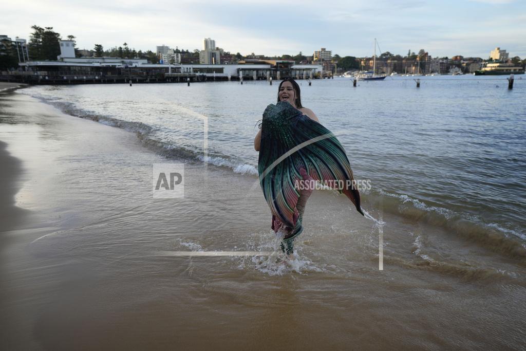 Mark Baker Lauren Metzler, founder of Sydney Mermaids, walks from the water at Manly Cove Beach in Sydney, Australia, Thursday, May 26, 2022. (AP Photo/Mark Baker)
