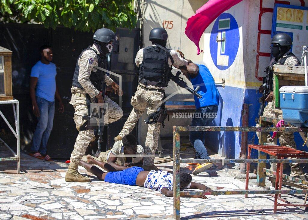Dieu Nalio Chery Police officers detain demonstrators during a protest to demand the resignation of Haitian President Jovenel Moise in Port-au-Prince, Haiti, Sunday, Feb. 7, 2021. ( AP Photo/Dieu Nalio Chery)