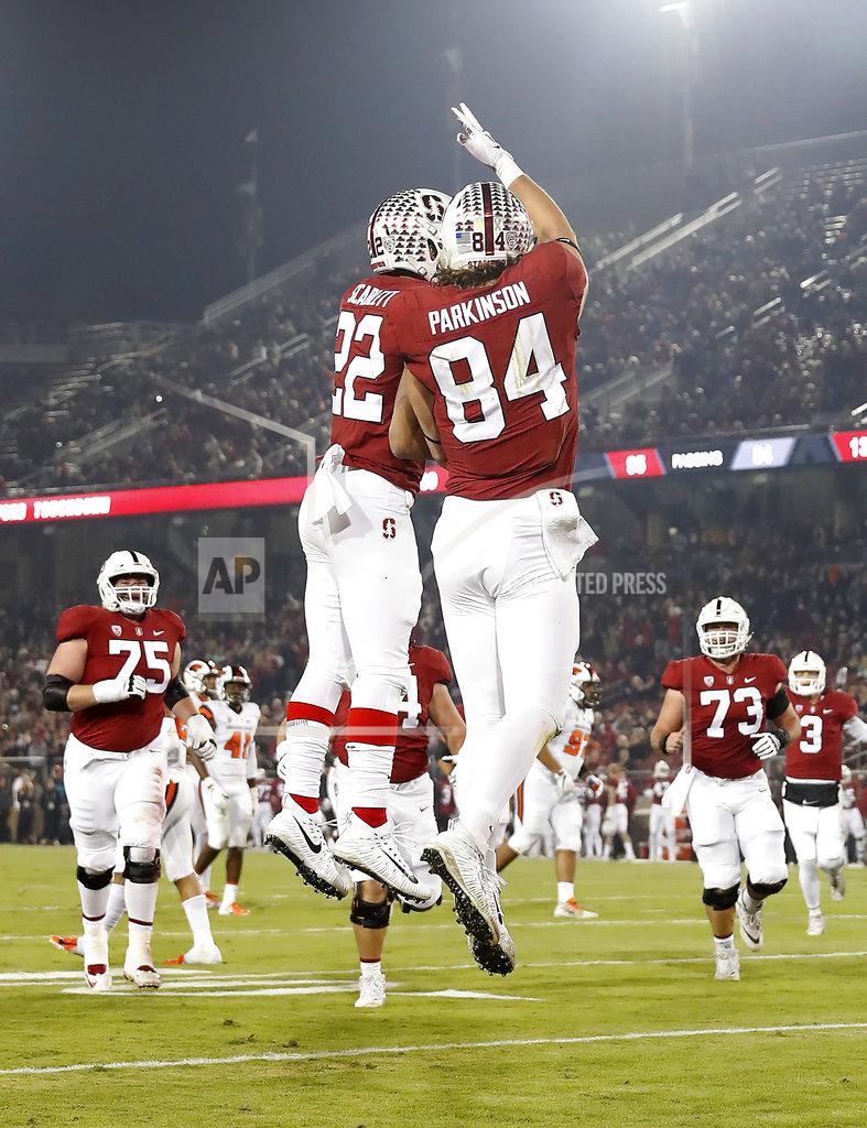 Tony Avelar CORRECTS DATE - Stanford tight end Colby Parkinson (84) celebrates with teammate Cameron Scarlett (22) after scoring a touchdown against Oregon State in the first half during an NCAA college football game on Saturday, Nov. 10, 2018, in Stanford, Calif. (AP Photo/Tony Avelar)