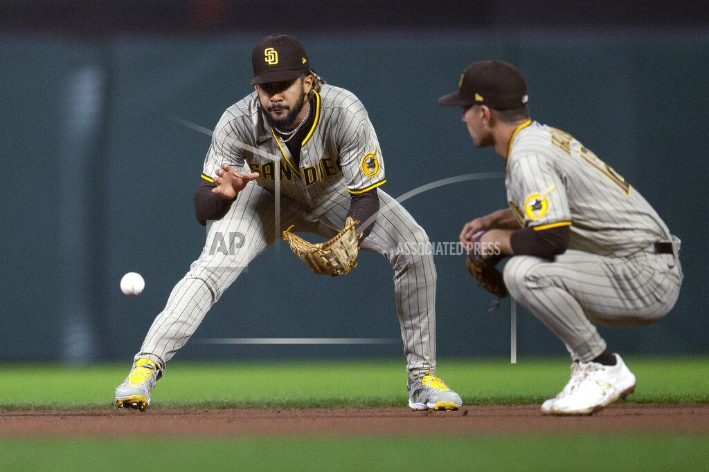 D. Ross Cameron San Diego Padres shortstop Fernando Tatis Jr., left, fields a grounder by San Francisco Giants' Steven Duggar in front of second baseman Adam Frazier during the fourth inning of a baseball game, Tuesday, Sept. 14, 2021, in San Francisco. A runner was forced at second, and Duggar was safe at first. (AP Photo/D. Ross Cameron)