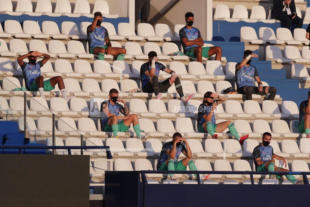 Real Madrid substitute players sit on the stands, observing social distancing to prevent the spread of coronavirus, prior to the Spanish La Liga soccer match between Leganes and Real Madrid at the Butarque Stadium in Leganes, on the outskirts of Madrid, Spain, Sunday, July 19, 2020. (AP Photo/Bernat Armangue)