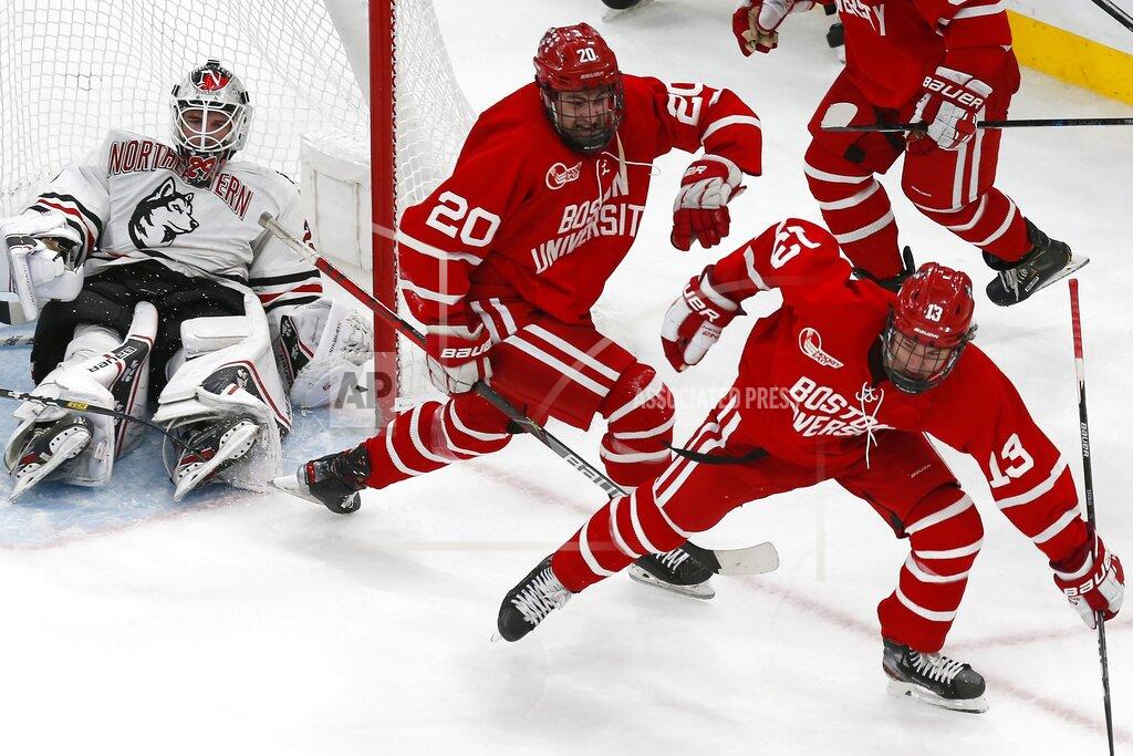Boston University's Trevor Zegras (13) celebrates his tying goal against Northeastern's Craig Pantano, left, during the third period of the Beanpot Tournament championship NCAA college hockey game in Boston, Monday, Feb. 10, 2020. (AP Photo/Michael Dwyer)