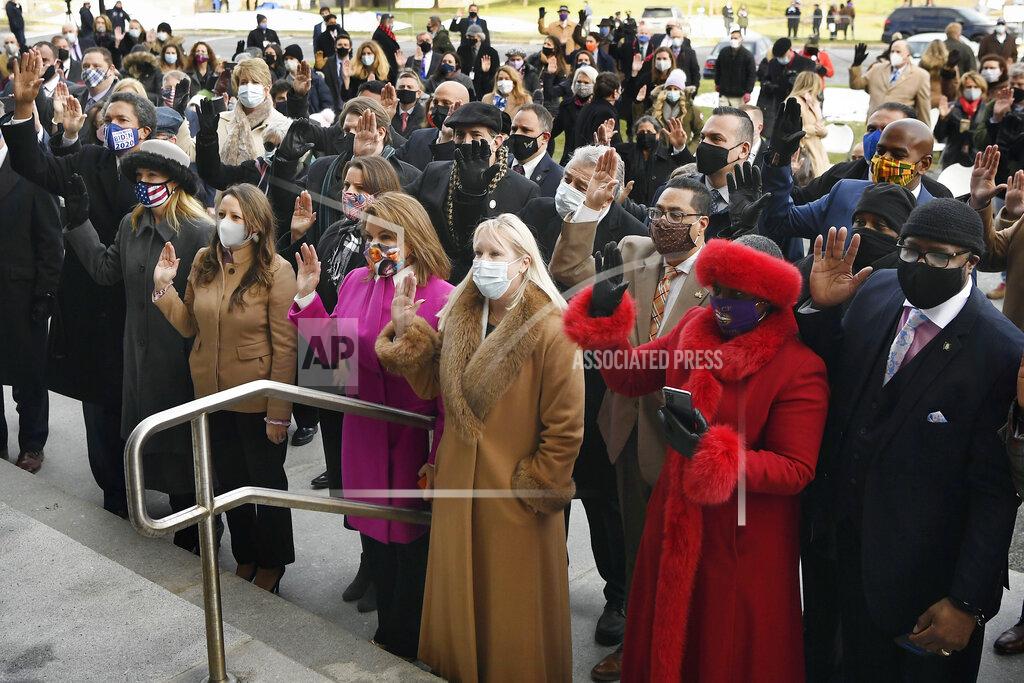 Jessica Hill Members of the House of Representatives take the oath of office outside on the State Capitol grounds, Wednesday, Jan. 6, 2021, in Hartford, Conn. The new legislative session is expected to focus on the continuing coronavirus pandemic and the state's budget challenges. (AP Photo/Jessica Hill)