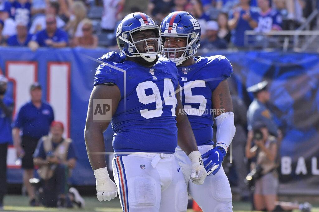 Bill Kostroun New York Giants' Dalvin Tomlinson, left, and B.J. Hill celebrates after a sack during the second half of an NFL football game against the Washington Redskins, Sunday, Sept. 29, 2019, in East Rutherford, N.J. (AP Photo/Bill Kostroun)