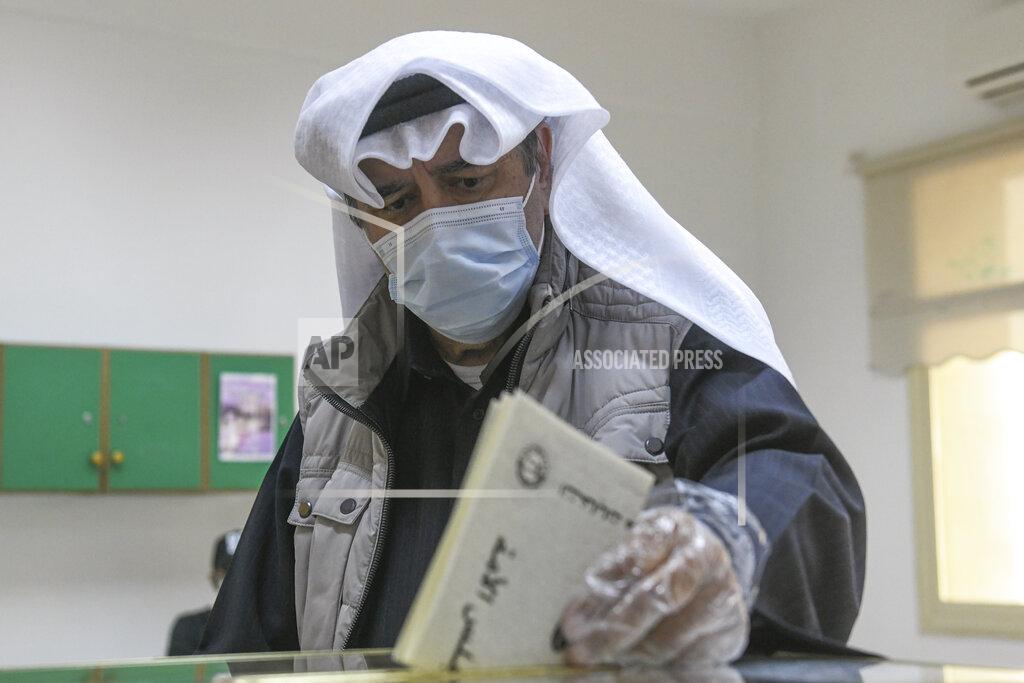 Jaber Abdulkhaleg FILE - In this Saturday, Dec. 5, 2020 file photo, a man casts his vote for parliamentary elections in the town of Hawally, Kuwait. A new parliament has been elected in Kuwait in an election that saw two-thirds of lawmakers and the country’s only female legislator lose their seats. Election results were released Sunday. (AP Photo/Jaber Abdulkhaleg, File)