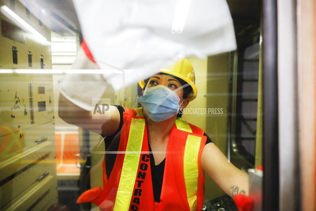 John Minchillo A contractor cleans a subway car at the 96th Street station to control the spread of COVID-19, Thursday, July 2, 2020, in New York. Mass transit systems around the world have taken unprecedented — and expensive — steps to curb the spread of the coronavirus, including shutting down New York subways overnight and testing powerful ultraviolet lamps to disinfect seats, poles and floors. (AP Photo/John Minchillo)