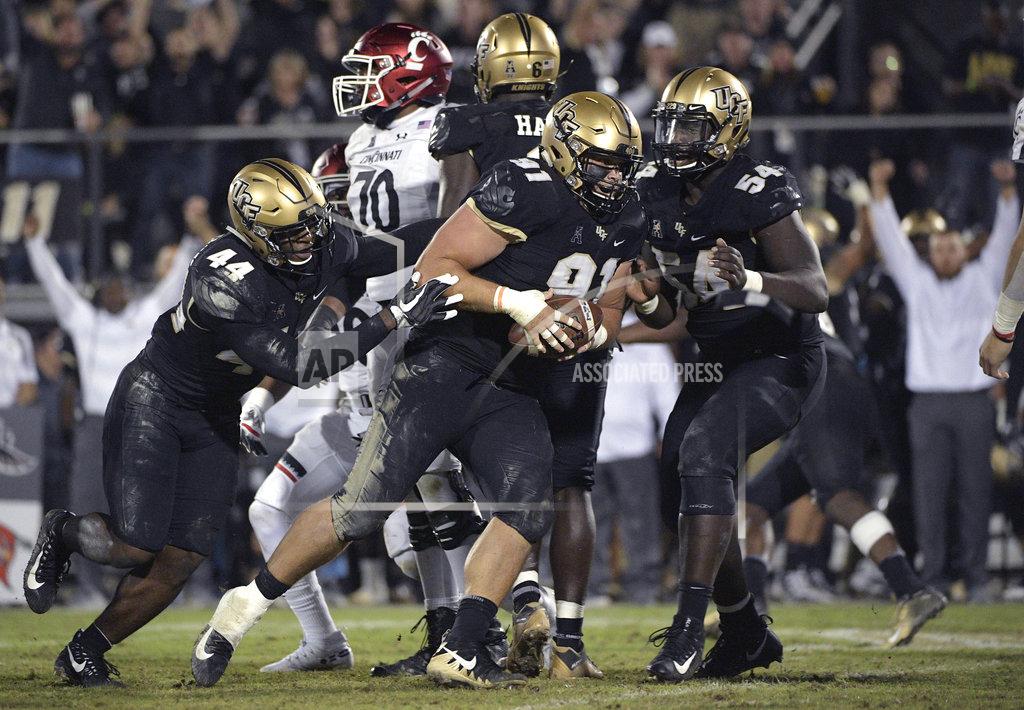 Phelan M. Ebenhack Central Florida defensive lineman Joey Connors (91) celebrates with linebacker Nate Evans (44) and defensive lineman A.J. Wooten (54) after recovering a fumble during the second half of an NCAA college football game against Cincinnati Saturday, Nov. 17, 2018, in Orlando, Fla. Central Florida won, 38-13. (AP Photo/Phelan M. Ebenhack)