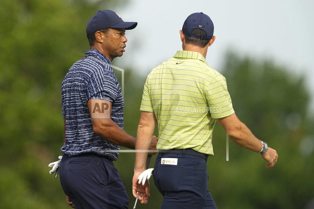Matt York Tiger Woods and Rory McIlroy, of Northern Ireland, walk on the 13th hole during the first round of the PGA Championship golf tournament Thursday, May 19, 2022, in Tulsa, Okla. (AP Photo/Matt York)