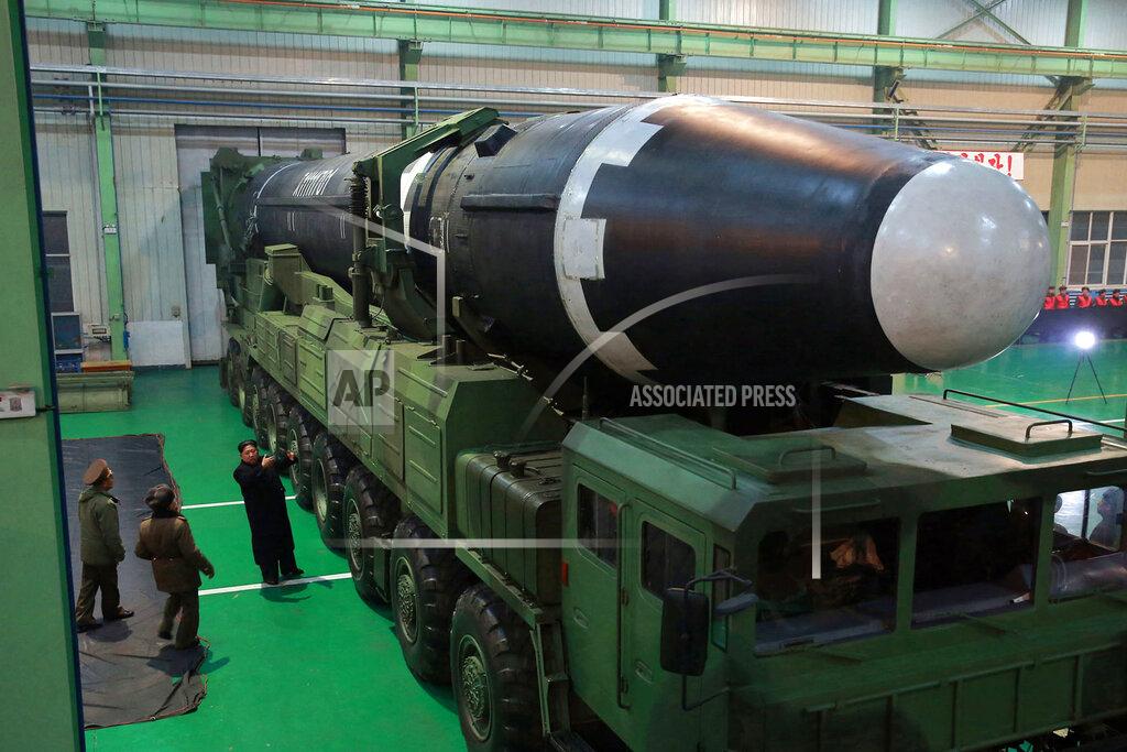 Uncredited FILE - This Nov. 29, 2017, file photo provided by the North Korean government shows North Korean leader Kim Jong Un, third from left, and what the North Korean government calls the Hwasong-15 intercontinental ballistic missile, in North Korea. As Americans celebrate or fume over the new president-elect, many in Asia are waking up to the reality of a Joe Biden administration with decidedly mixed feelings. Relief and hopes of economic and environmental revival jostle with needling anxiety and fears of inattention. Biden has endorsed a slower approach built from working-level meetings and said he would be willing to tighten sanctions on the North until it takes concrete denuclearization steps. (Korean Central News Agency/Korea News Service via AP, File)