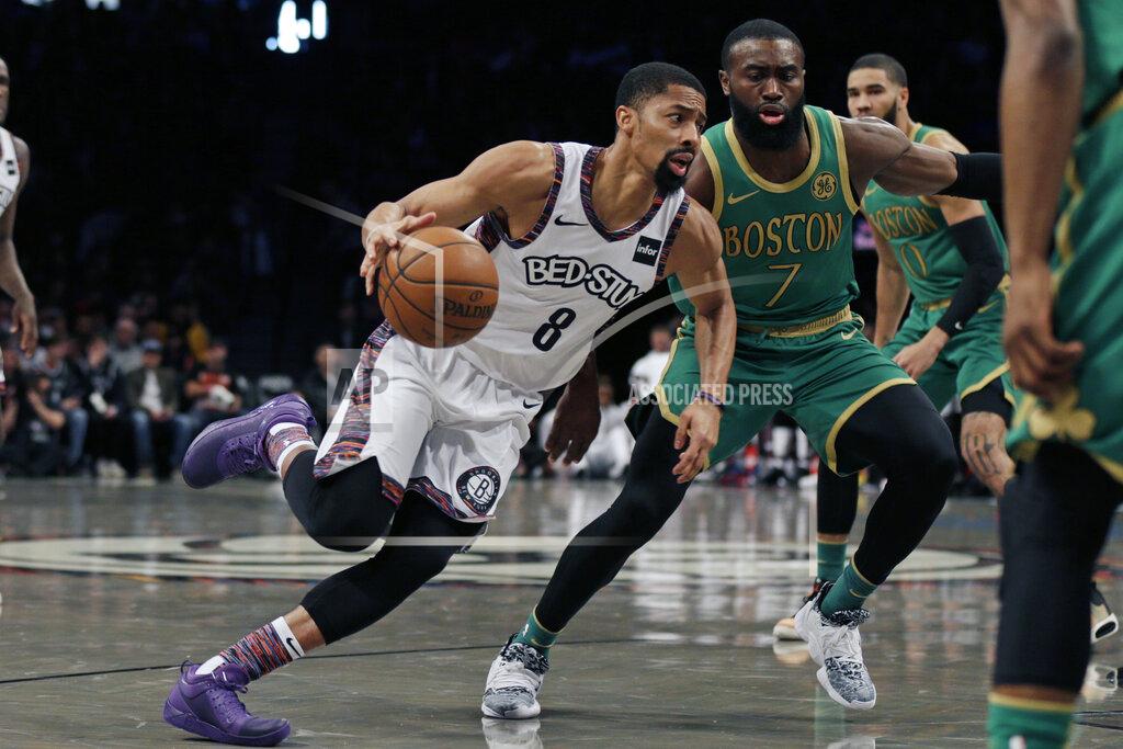 Brooklyn Nets guard Spencer Dinwiddie (8) drives to the basket past Boston Celtics guard Jaylen Brown (7) during the first half of an NBA basketball game Friday, Nov. 29, 2019, in New York. (AP Photo/Adam Hunger)