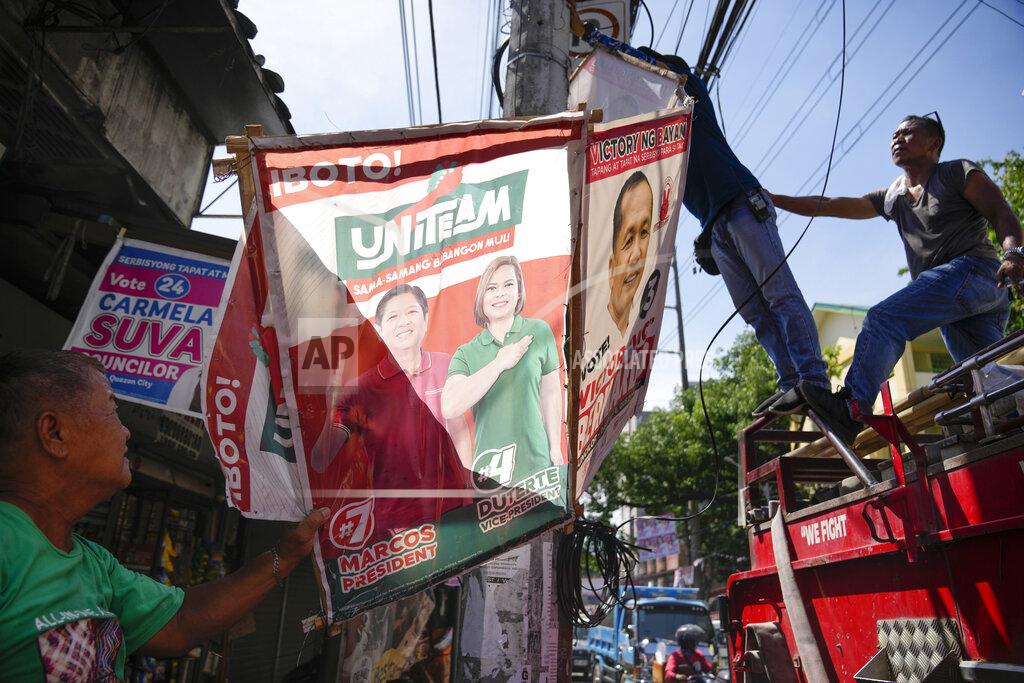 Aaron Favila Village workers remove a campaign poster showing Presidential candidate Ferdinand "Bongbong" Marcos Jr. and running mate Sara Duterte along a street in Quezon city, Philippines on Wednesday, May 11, 2022. Marcos, the namesake son of longtime dictator Ferdinand Marcos, apparent landslide victory in the Philippine presidential election is raising immediate concerns about a further erosion of democracy in Asia and could complicate American efforts to blunt growing Chinese influence and power in the Pacific. (AP Photo/Aaron Favila)