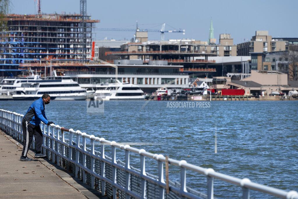 Jacquelyn Martin In this Friday March 19, 2021, photo a man exercises across a waterway from Fort McNair, with Washington's Wharf neighborhood in the background, in Washington. Iran has made threats against Fort McNair, a U.S. army base in Washington DC, and against the Army’s vice chief of staff, according to two senior U.S. intelligence officials, who spoke on condition of anonymity to discuss national security matters. The threats are one reason the Army has been pushing for more security around the base, which sits alongside the bustling Waterfront district of Washington DC. (AP Photo/Jacquelyn Martin)