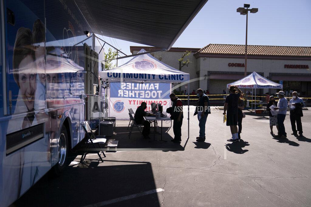 Jae C. Hong People check in to receive the Moderna COVID-19 vaccine at a mobile clinic set up in the parking lot of a shopping center in Orange, Calif., Thursday, April 29, 2021. The mobile unit, launched in February by Families Together of Orange County, began its service to provide better access to the COVID-19 vaccine within the community and to prevent vaccine hesitation, according to mobile operations manager Parsia Jahanbani. (AP Photo/Jae C. Hong)