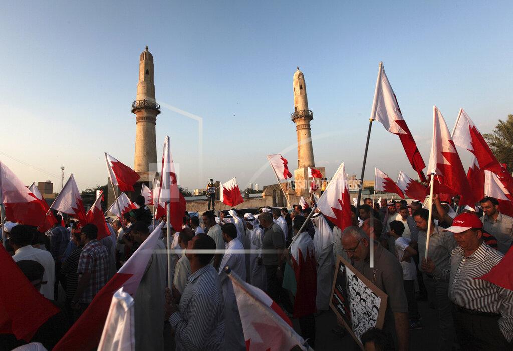 Hasan Jamali File - In this Friday, Nov. 22, 2013 file photo, Bahraini anti-government protesters wave national flags during a march in Manama, Bahrain. A decade ago, against all odds, a popular uprising convulsed the monarchy of Bahrain as a wave of revolutionary protests swept across the Middle East. But after a brutal crackdown and years of escalating repression, activists say the small kingdom is less free now than even before the Arab Spring, as authorities crush hopes for political reform. (AP Photo/Hasan Jamali, File)