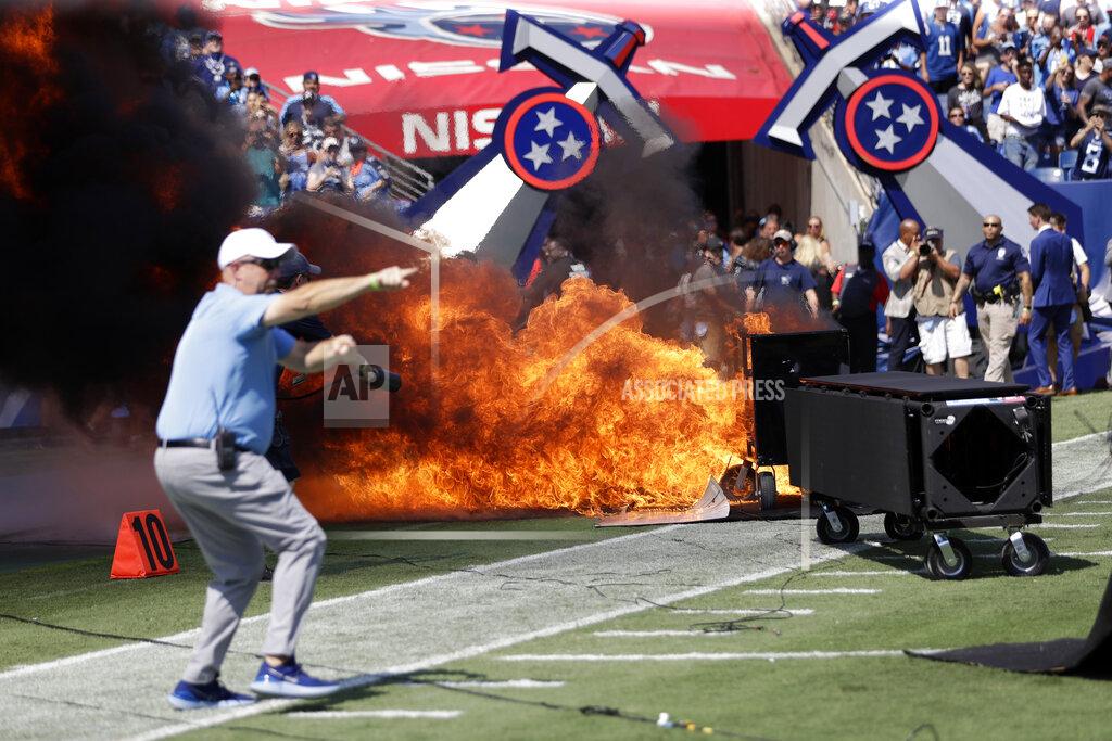 James Kenney FILE - In this Sunday, Sept. 15, 2019, file photo, a fire from a pyrotechnics machine burns on the field before an NFL football game between the Tennessee Titans and the Indianapolis Colts, in Nashville, Tenn. The NFL has banned any on-field pyrotechnics and "flame effects" at any league or team events, including games, in the wake of an incident at last Sunday's game at Nissan Stadium. (AP Photo/James Kenney, File)
