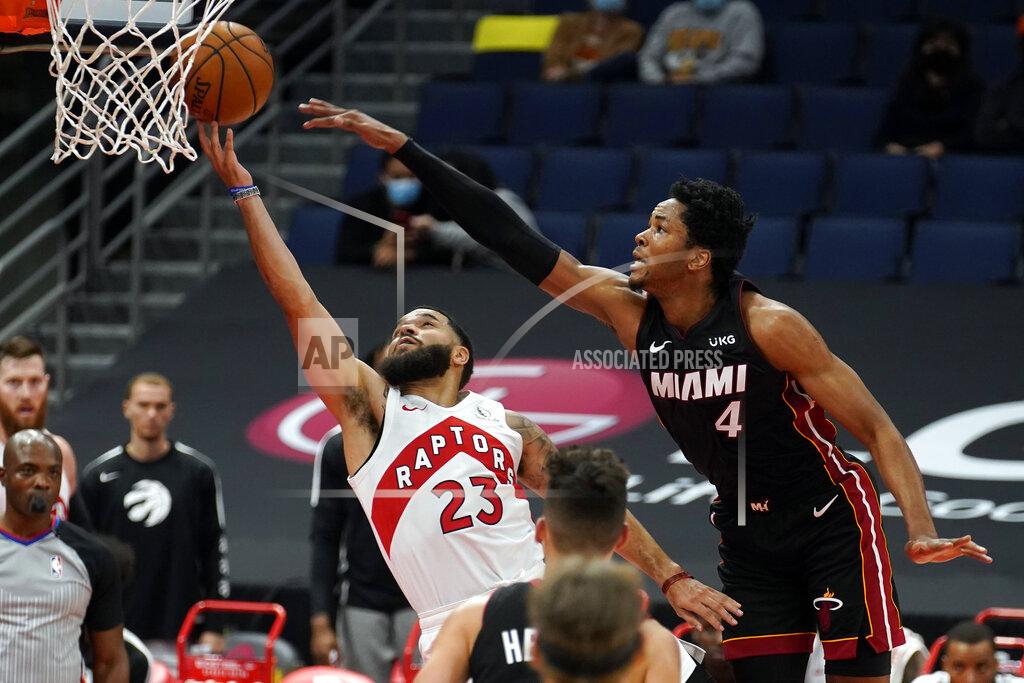 Chris O'meara Toronto Raptors guard Fred VanVleet (23) gets fouled by Miami Heat forward KZ Okpala (4) during the first half of an NBA preseason basketball game Friday, Dec. 18, 2020, in Tampa, Fla. The Raptors are playing their home games in Tampa as a result of Canada's strict travel regulations stemming from the coronavirus pandemic. (AP Photo/Chris O'Meara)