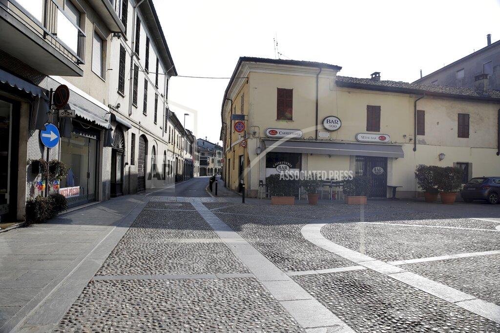 Luca Bruno FILE - A deserted road in the town of Codogno, near Lodi, Northern Italy, in this Saturday, Feb. 22, 2020 file photo. Italy delivered the first shocking confirmation of locally transmitted coronavirus infections outside of Asia a year ago Sunday, with back-to-back revelations of cases more than 150 kilometers (nearly 100 miles) apart in the country's north. First, a 38-year-old man in Codogno, an industrial town in the Lombardy region, tested positive for COVID-19, sending panicked residents to pick up their children from school, stock up on provisions at grocery stores and search in vain for surgical masks at pharmacies.. (AP Photo/Luca Bruno)