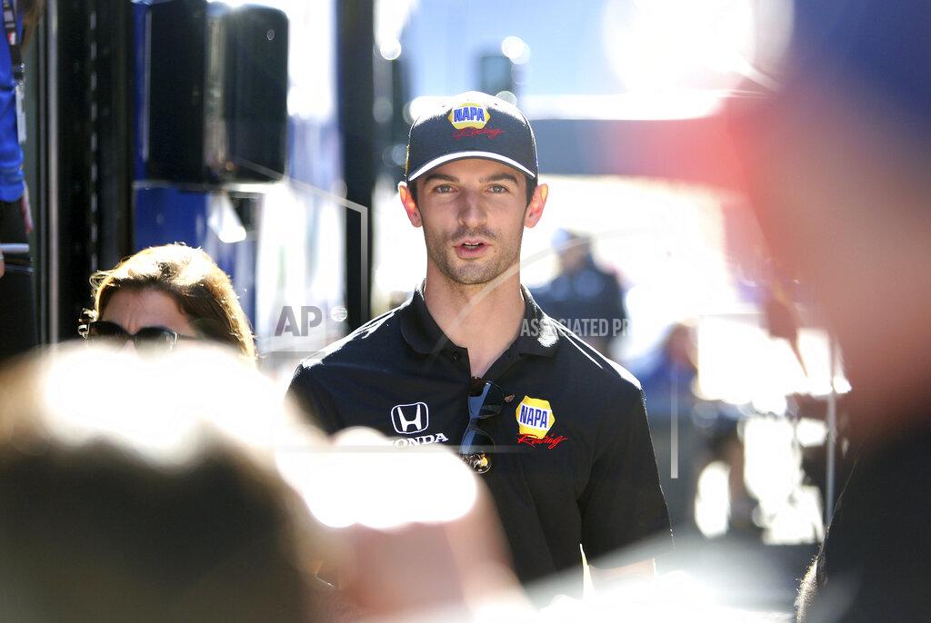 Elias Funez Driver Alexander Rossi greets fans and gives autographs before an IndyCar auto race at Laguna Seca Raceway in Monterey, Calif., Sunday, Sept. 22, 2019. (Elias Funez/The Union via AP)