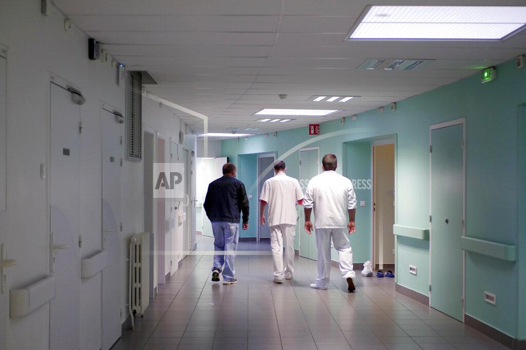 Thibault Camus Medical staff of the emergency ward of the Rouvray psychiatric hospital accompany a patient to his room, in Rouen, western France, Wednesday, Nov. 25, 2020. Lockdowns that France has used to fight the coronavirus have come at considerable cost to mental health. Surveying points to a surge of depression most acute among people without work, in financial hardship and young adults. (AP Photo/Thibault Camus)