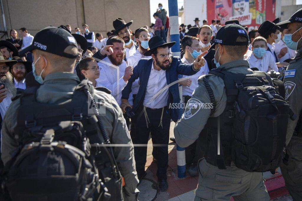 Oded Balilty File - In this Sunday, Jan. 24, 2021 file photo, Ultra-Orthodox Jews argue with Israeli border police officers during a protest over the coronavirus lockdown restrictions, in Ashdod, Israel. (AP Photo/Oded Balilty, File)