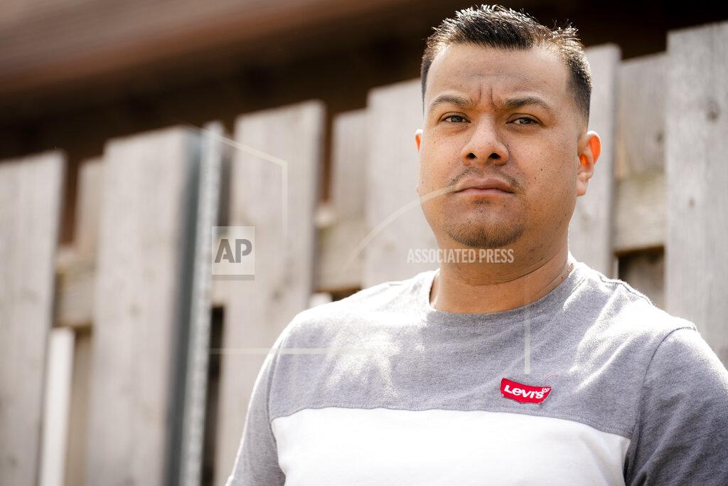 John Minchillo Fidel Martinez stands for a portrait at one of his former worksites in Minneapolis on Sunday, April 18, 2021. Martinez worked for a demolition contractor in the fall of 2020, demolishing several Walgreens stores and other structures. Martinez said the contractor owed him and his co-workers more than $20,000. His boss kept telling him the money was coming, but he would get his paychecks weeks late, and many of them he didn't get at all. (AP Photo/John Minchillo)