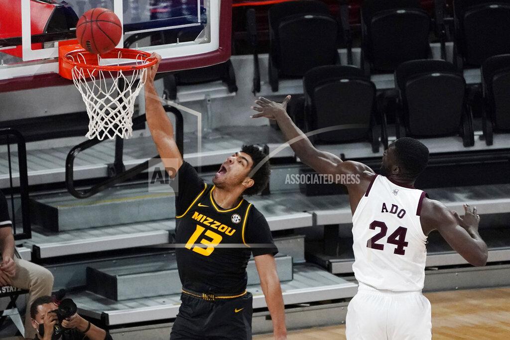 Rogelio V. Solis Missouri guard Mark Smith (13) tries for a dunk next to Mississippi State forward Abdul Ado (24) during the first half of an NCAA college basketball game Tuesday, Jan. 5, 2021, in Starkville, Miss. (AP Photo/Rogelio V. Solis)