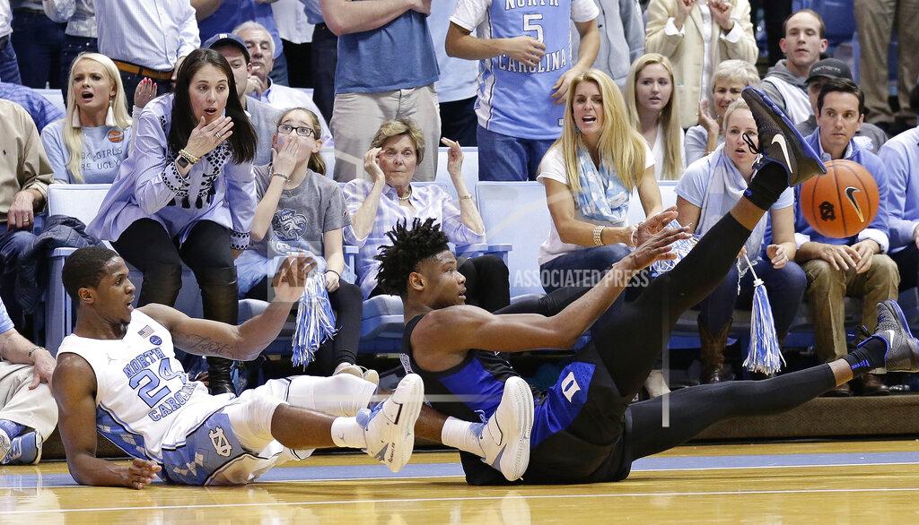 Gerry Broome North Carolina's Kenny Williams (24) falls to the floor with Duke's Cam Reddish during the second half of an NCAA college basketball game in Chapel Hill, N.C., Saturday, March 9, 2019. North Carolina won 79-70. (AP Photo/Gerry Broome)