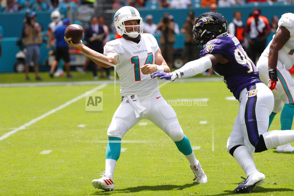 Wilfredo Lee Miami Dolphins quarterback Ryan Fitzpatrick (14) looks to pass under pressure from Baltimore Ravens outside linebacker Matt Judon (99), during the first half at an NFL football game Sunday, Sept. 8, 2019, in Miami Gardens, Fla. (AP Photo/Wilfredo Lee)