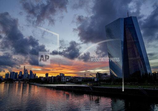 FILE - In this July 4, 2021 file photo, the European Central Bank, right, is seen as clouds drift over Frankfurt, Germany. Germany’s leading economic institutes has downgraded their forecast for Europe’s biggest economy saying it is still shaped by the impact of the coronavirus pandemic and that global supply bottlenecks also hamper the country’s recovery. (AP Photo/Michael Probst, File)