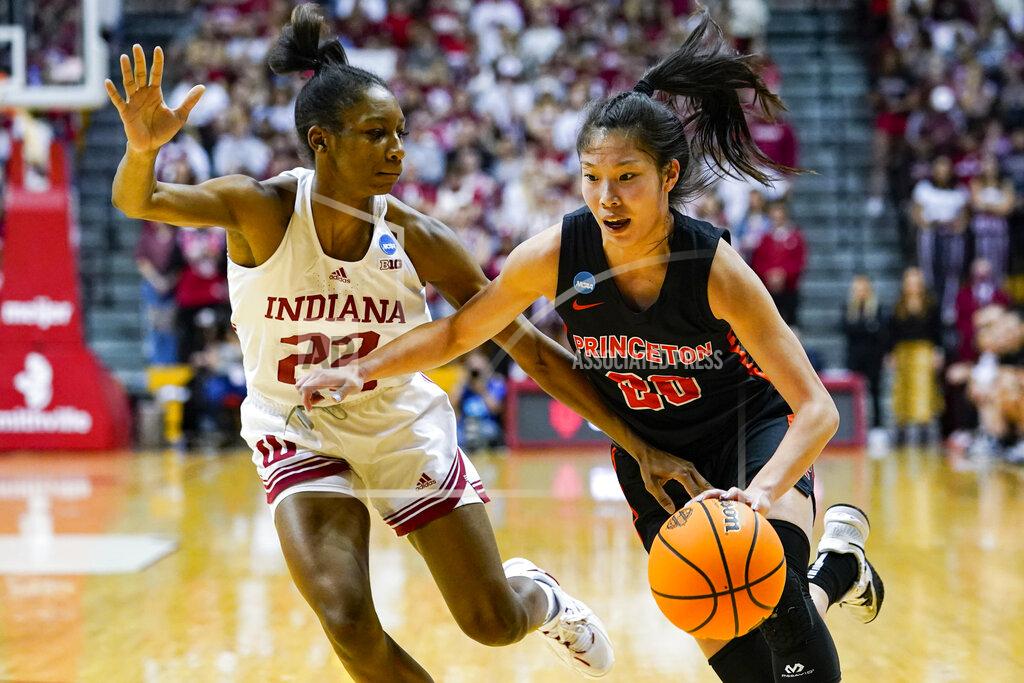 Michael Conroy Princeton guard Kaitlyn Chen (20) drives on Indiana guard Chloe Moore-McNeil (22) in the first half of a college basketball game in the second round of the NCAA tournament in Bloomington, Ind., Monday, March 21, 2022. (AP Photo/Michael Conroy)