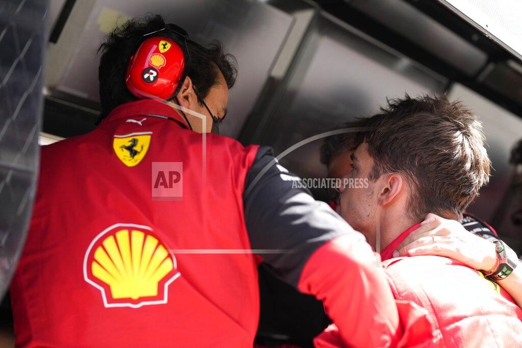 Manu Fernandez Ferrari driver Charles Leclerc of Monaco reacts as he speaks with his teammates at the pit lane after his car's breakdown during the Spanish Formula One Grand Prix at the Barcelona Catalunya racetrack in Montmelo, Spain, Sunday, May 22, 2022. (AP Photo/Pool/Manu Fernandez)