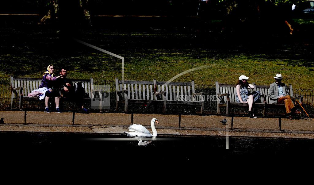 Frank Augstein People obey social distancing in a park in London, Wednesday April 22, 2020, as the lockdown in Britain continues due to the coronvirus pandemic. (AP Photo/Frank Augstein)