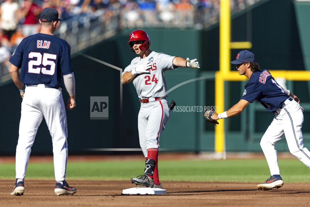 John Peterson Arkansas' Braydon Webb (24) celebrates hitting a double in the first inning against Mississippi first baseman Tim Elko (25) and second baseman Peyton Chatagnier (1) during an NCAA College World Series baseball game Wednesday, June 22, 2022, in Omaha, Neb. (AP Photo/John Peterson)
