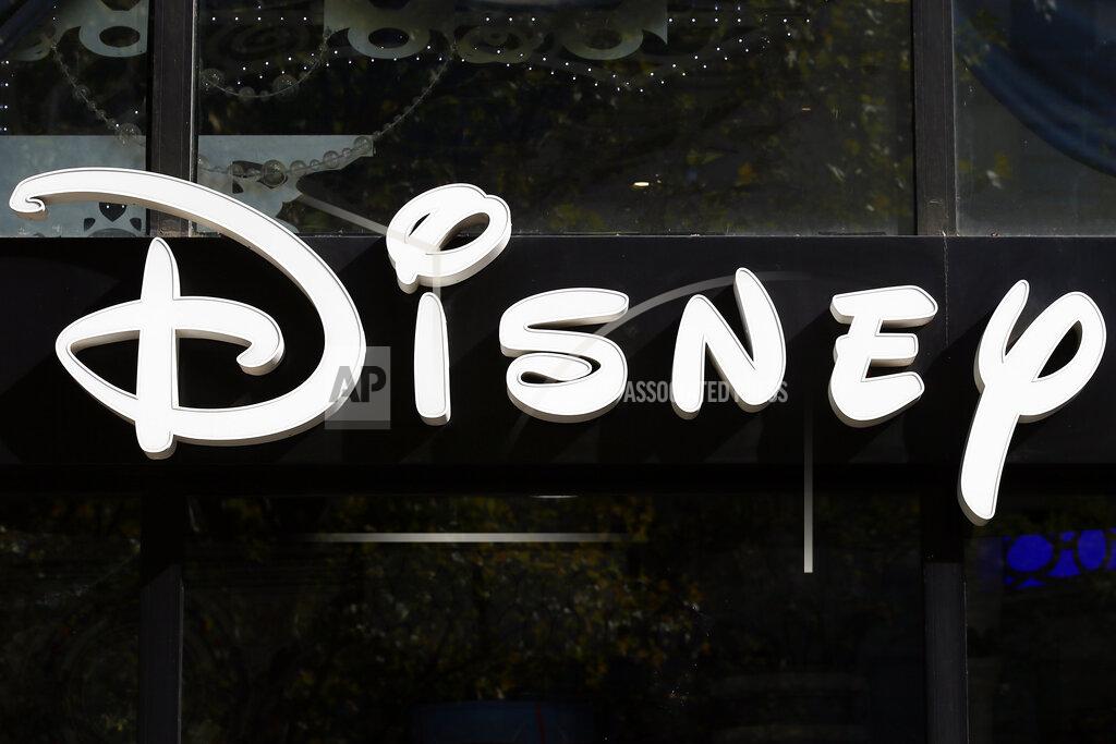 Francois Mori FILE - This Sept. 20, 2017, file photo shows a sign at the Disney store on the Champs Elysees Avenue in Paris. After the U.S. Supreme Court revoked the federal right to an abortion that's been in place for half a century, companies like Amazon, Disney, Apple and JP Morgan pledged to cover travel costs for employees who live in states where the procedure is now illegal so they can terminate pregnancies. (AP Photo/Francois Mori, File)