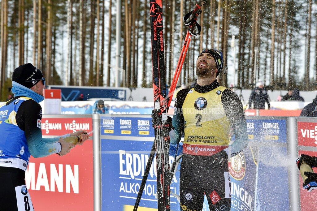 Jussi Nukari Simon Desthieux, left, of France sprays champagne at Martin Fourcade of France who celebrates victory and the end of career after winning the men's 12.5 km Pursuit competition at the IBU Biathlon World Cup in Kontiolahti, Finland, on Saturday March 14, 2020. Fourcade ends his career after today's competition that ends the season, exactly ten years after he took his first World Cup victory in Kontiolahti. (Jussi Nukari/Lehtikuva via AP)