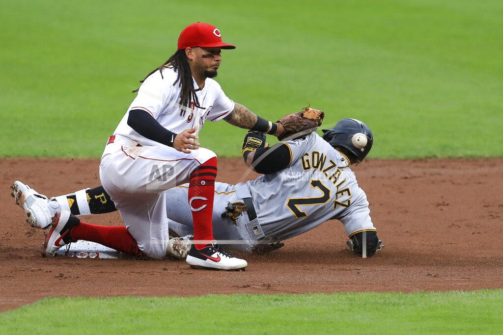 Aaron Doster Cincinnati Reds' Freddy Galvis (3) attempts to field the ball as Pittsburgh Pirates' Erik Gonzalez (2) is safe after hitting a double in the second inning during a baseball game at in Cincinnati, Friday, Aug. 14, 2020. (AP Photo/Aaron Doster)