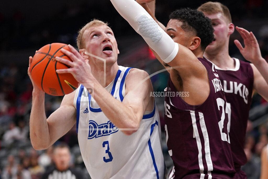 Jeff Roberson Drake's Garrett Sturtz, left, looks to the basket as Southern Illinois' Steven Verplancken Jr. defends during the first half of an NCAA college basketball game in the quarterfinal round of the Missouri Valley Conference tournament Friday, March 4, 2022, in St. Louis. (AP Photo/Jeff Roberson)