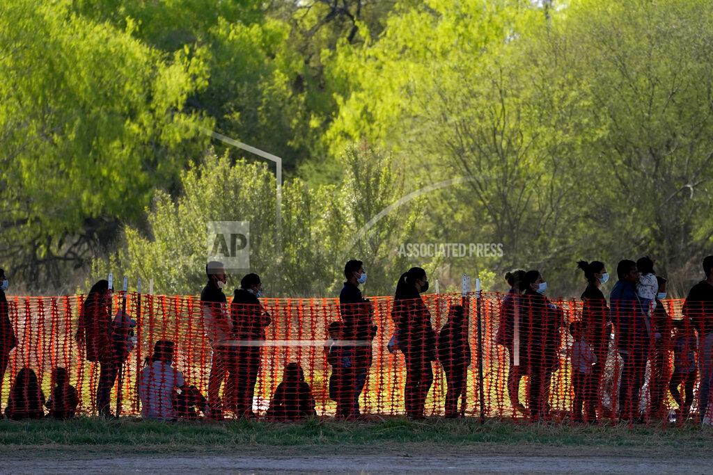 Julio Cortez FILE - In this March 19, 2021, file photo, migrants are seen in custody at a U.S. Customs and Border Protection processing area under the Anzalduas International Bridge, in Mission, Texas. U.S. authorities say they picked up nearly 19,000 children traveling alone across the Mexican border in March. It's the largest monthly number ever recorded and a major test for President Joe Biden as he reverses many of his predecessor's hardline immigration tactics. (AP Photo/Julio Cortez, File)
