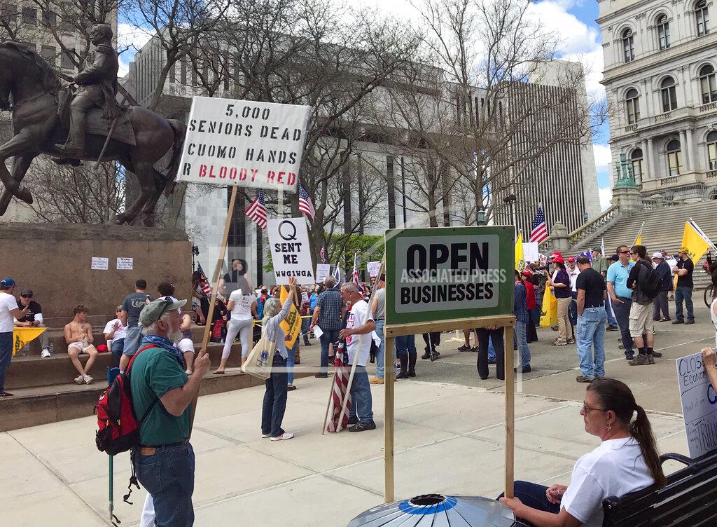 Marina Villeneuve Protesters gather near the State Capitol in Albany, N.Y., calling for the state to reopen the economy, Saturday, May 16, 2020. During N.Y. Gov. Andrew Cuomo's news conference on Saturday, he mention some additional loosening up of COVID-19 related restrictions but cautioned that the state could see a rise in cases as the economy opens up. To avoid another spike, people will still need to take precautions like social distancing, he said. (AP Photo/Marina Villeneuve)